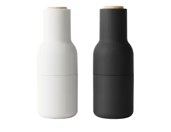 Audo Bottle Grinders in light grey and charcoal with bottle-shaped bodies and pale wooden lids