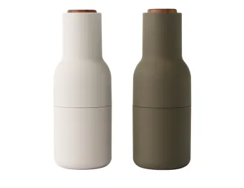 Audo Bottle Grinders in hunting green and off-white with dark wooden lids and curved bottle-shaped bodies