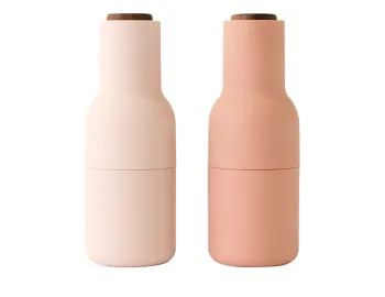 Audo Bottle Grinders in pale pink and peach with brown wooden lids and rounded bottle-shaped bodies