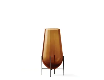 Amber Échasse Vase with a tapered body and rounded bottom raised on a slender dark four-legged stand