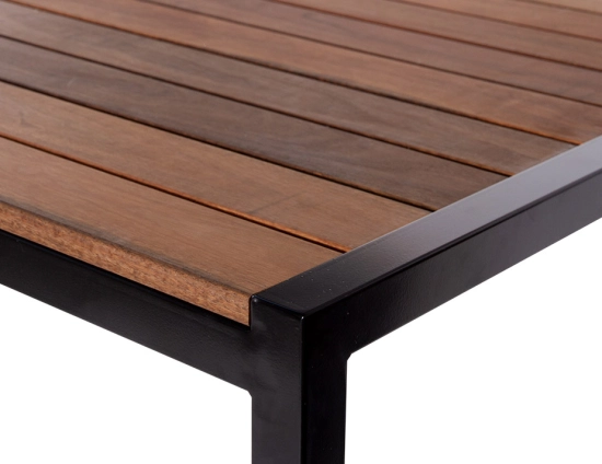 Close-up of the Moonah Dining Table showing brown slats inset into a black corner frame