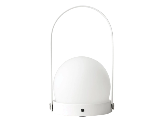 White Carrie Table Lamp with a round globe shade, circular base and tall arched carry handle