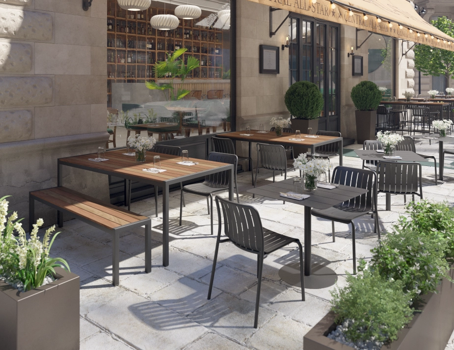 Moonah Dining Tables with brown slats and charcoal frames among chairs on a restaurant terrace