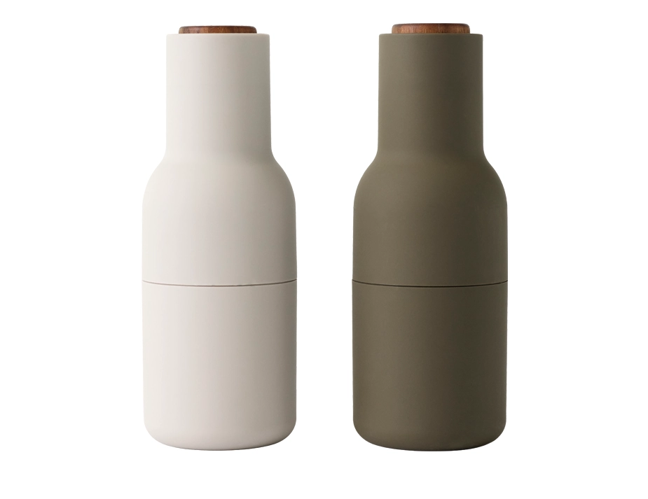 Audo Bottle Grinders in hunting green and off-white with dark wooden lids and curved bottle-shaped bodies